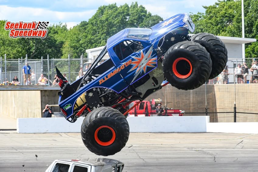 Illuminator Monster Truck flying crooked after smashing a full-sized van during the freestyle competition at Seekonk Speedway in Seekonk, MA, USA