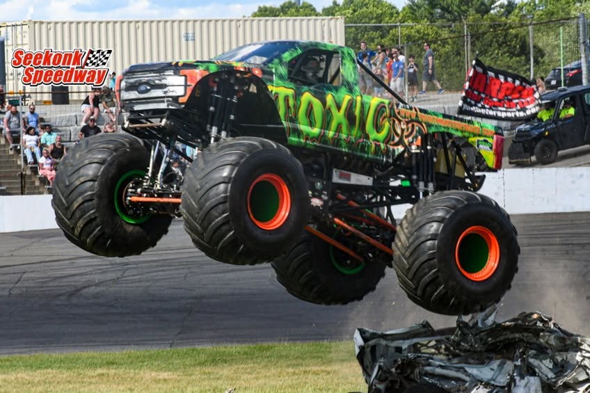 Toxic Monster Truck crushing a junk sedan and full-sized van during the freestyle competition at Seekonk Speedway in Seekonk, MA, USA