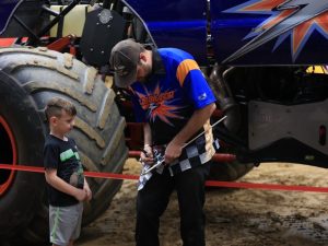 Cory Snyder, driver of Illuminator Monster Truck, signing autographs