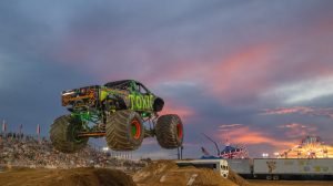 Toxic Monster Truck taking a big leap during the racing competition at the Montgomery County Fair in Gaithersburg, Maryland right at sunset