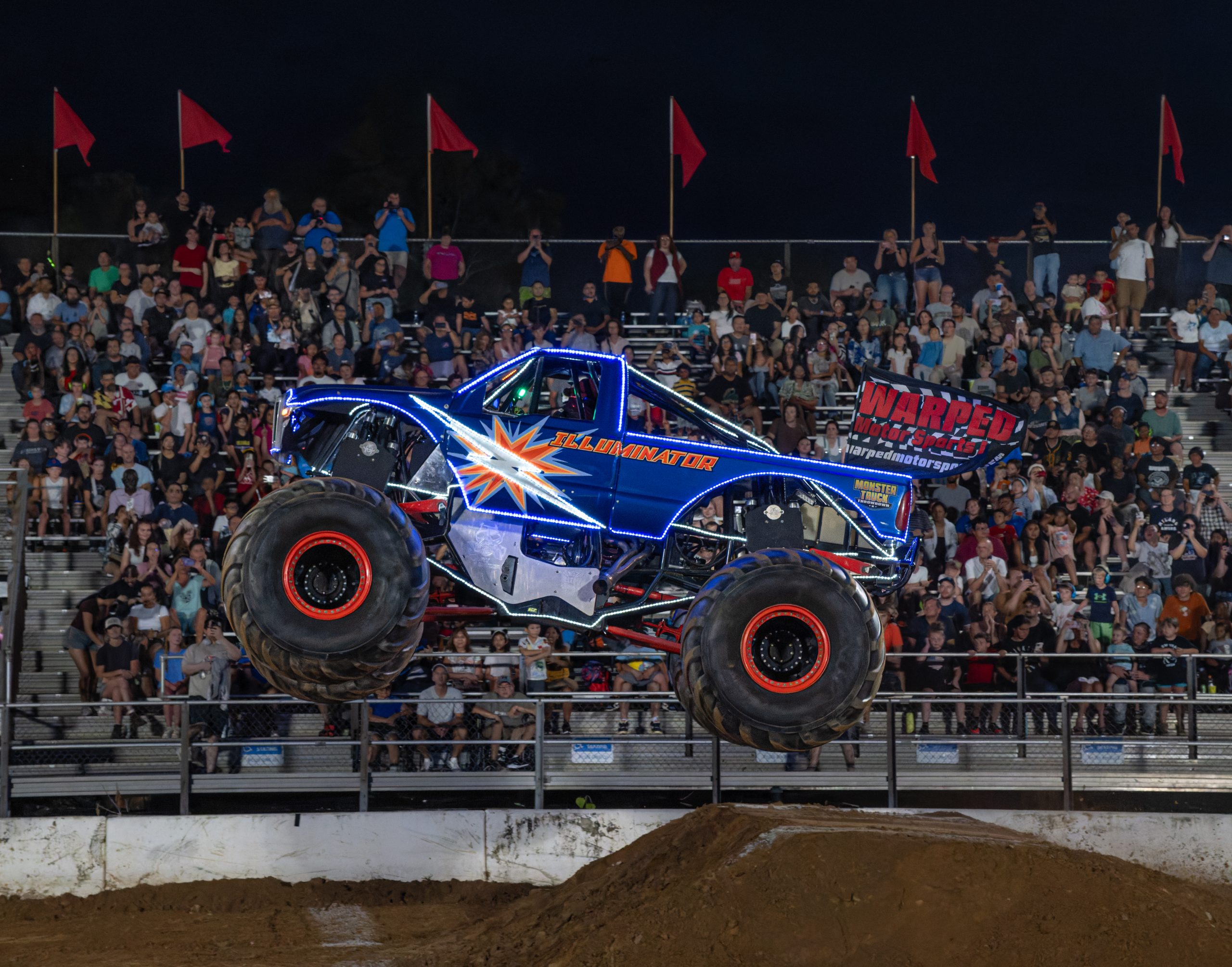 Illuminator monster truck catching some hang time in front of the sold out audience in Gaithersburg, MD at the Montgomery County Fair